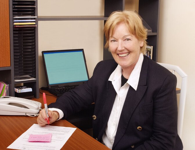 Happy business woman at desk
