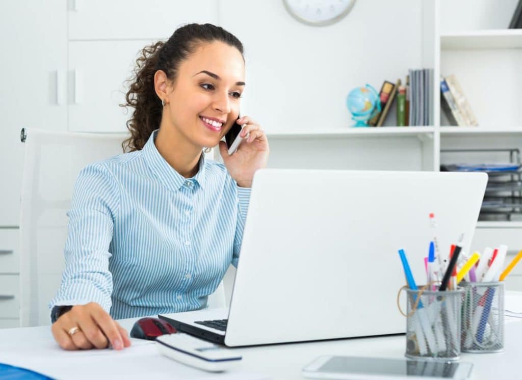 Woman on the phone and computer - Getting Started with the NDS Reseller Program